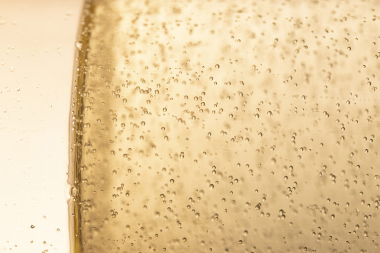 side view glass with champagne bubbles