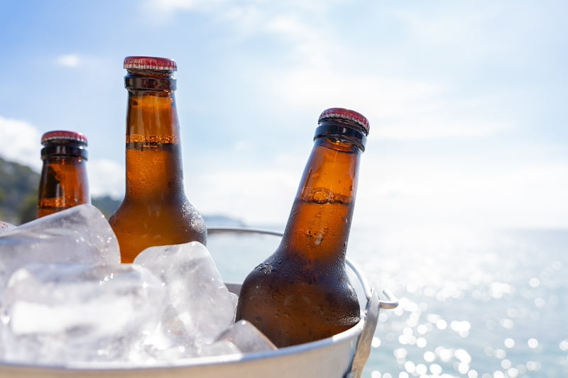 close,up,of,bucket,with,beer,bottles,cooling,with,lots